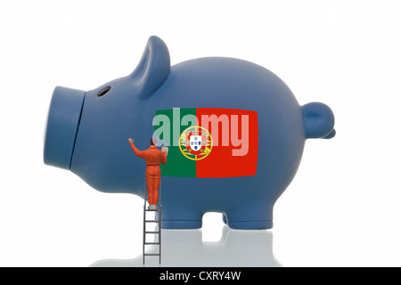 Miniaturmalerei Figur über eine portugiesische Nationalflagge auf ein blaues Sparschwein, symbolisches Bild Stockfoto