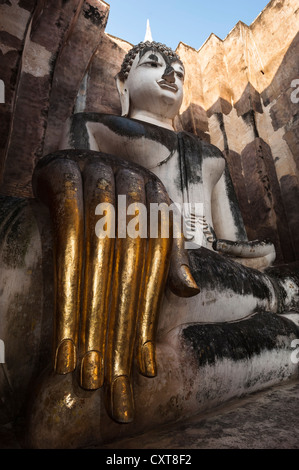 Sitzende Buddha-Statue mit seiner Hand verziert mit Blattgold, Wat Sri Chum Tempel, Sukhothai Historical Park Stockfoto