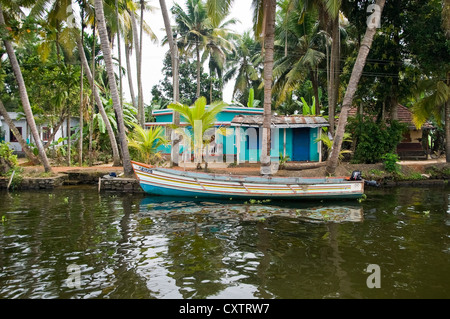 Horizontalen Weitwinkel aus mehreren traditionellen Häusern entlang des Flussufers in Kerala. Stockfoto