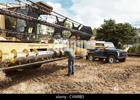 Landwirt Prüfung Dreschmaschine auf Bauernhof Stockfoto