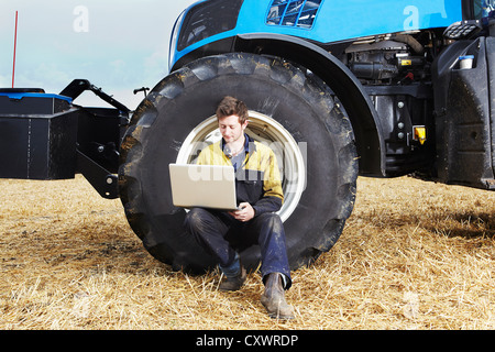 Landwirt mit Laptop in Feld Stockfoto