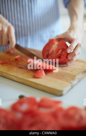 Nahaufnahme des Mannes Tomate schneiden Stockfoto