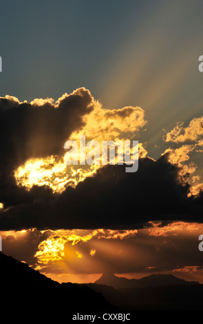 Die Sonne beleuchtet Baboquivari Peak, (in der Ferne links), 50 Meilen südwestlich von Tucson, Arizona, USA. Stockfoto