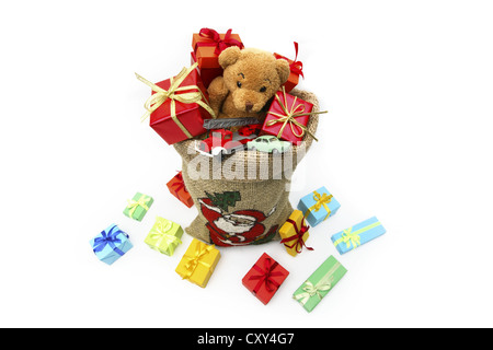 Christms Sack voller Weihnachten Geschenke, ein Teddybär und Spielzeugautos Stockfoto