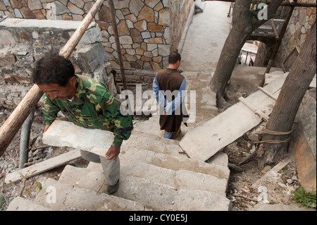 Arbeiter heben schwere Felsen im San Huang Zhai Kloster am Berg Song, China Stockfoto