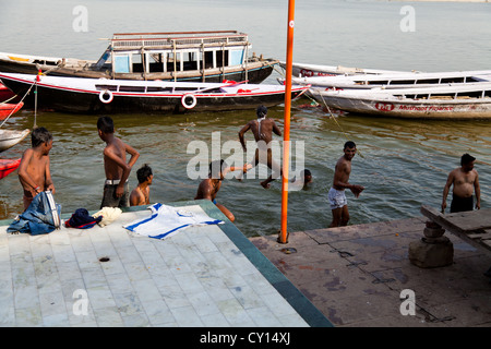 Junge Männer springen in den Fluss Ganges in Varanasi, Indien Stockfoto