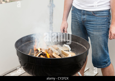 Grillmeister beim Zünden des Feuers des Grills Stockfoto