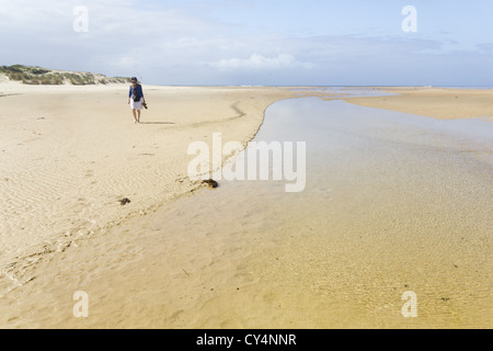 Frau am Strand entlang bei Manyana, NSW Stockfoto