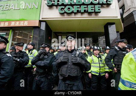 Polizei Wache Starbucks während gegen Sparpolitik und anti-Kürzungen Protest organisiert von der TUC marschierten durch durch die Londoner Stockfoto