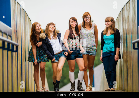 Eine Gruppe von fünf 5 jungen Heranwachsenden britisches Englisch Walisisch Teen Teenager Freunden zusammenstehen im freien UK