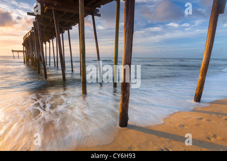 Cape Hatteras National Seashore, Avon, North Carolina Sunrise Reflexionen über Surf und Wellen unter dem Avon Fishing pier Stockfoto
