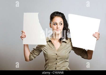 Porträt einer wunderschöne junge Brinette Frau mit zwei Hälften zerrissen leere weiße Billboad. Stockfoto