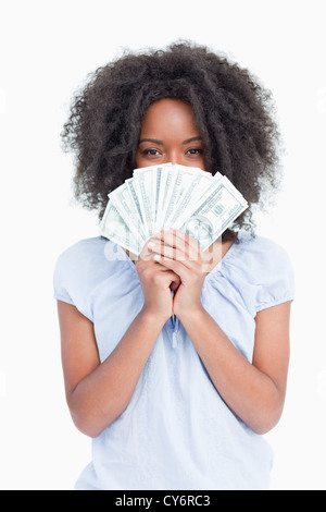 Junge lockig Frau verbirgt ihr Gesicht hinter einem Fan von Dollar Stockfoto