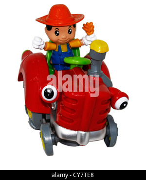 Ein Spielzeug-Fahrer auf seinem Traktor hält ein Korn-Brot Stockfoto