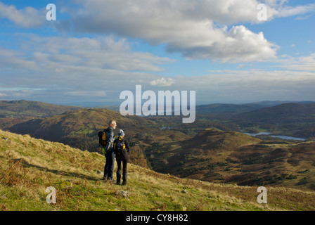 Zwei Wanderer auf Silber wie, mit Blick auf die Seen von Elterwater und Windermere, Lake District National Park, Cumbria, UK Stockfoto