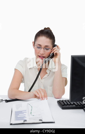 Porträt einer Geschäftsfrau telefonieren beim Betrachten eines Dokuments Stockfoto