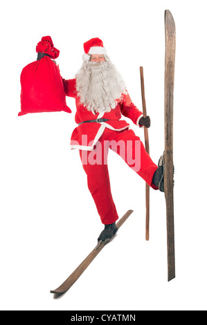 Santa Claus mit Tasche auf Skiern Stockfoto