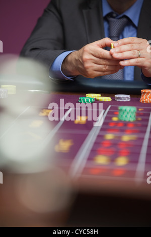 Mann beim Roulette Wette wird platziert Stockfoto