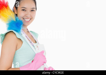 Glückliche Frau mit Staubwedel Stockfoto