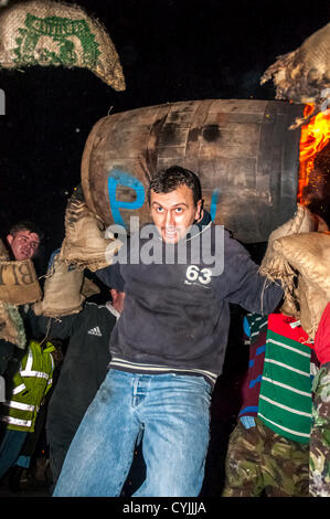 Fass Rollen laufen durch die Menge und die Straßen schon St Mary mit einem brennenden Teer Lauf während der 2012-Tar barrel Burning in schon St Mary, Devon, UK. 5. November 2012. Stockfoto