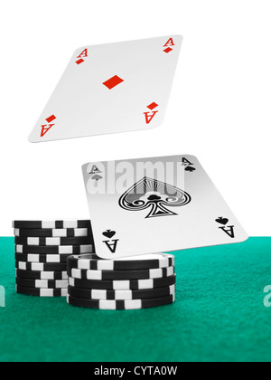 Zwei Asse fliegen über einen Stapel Chips auf dem Pokertisch. Stockfoto