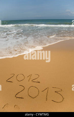 2012 und 2013 im Sand am Strand mit Wellen des Meeres beginnt, löschen Sie das Wort geschrieben Stockfoto