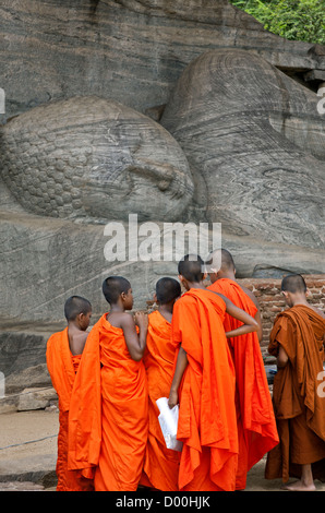 Novizen einen liegenden Buddha zu betrachten. Gal Vihara. Antike Stadt Polonnaruwa. Sri Lanka Stockfoto