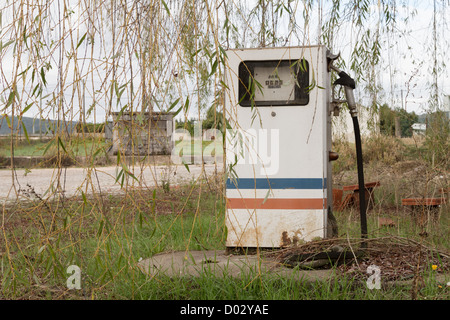 Alte, rostige und verlassene Tankstelle gegen die Natur Stockfoto