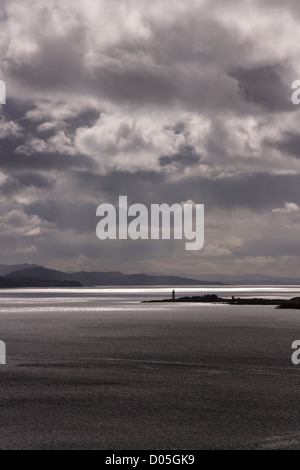 Dramatische Himmel und Sonne über Sound of Sleat mit Isle Ornsay Leuchtturm in Ferne, Schottland, Großbritannien Stockfoto