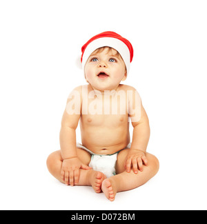 Foto von Baby Boy tragen Weihnachtsmann Hütchen, kleine niedliche Kind sitzt in Windel isoliert auf weißem Hintergrund, schönes Kind Stockfoto