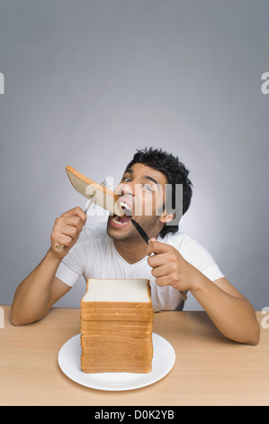 Mann isst ein Stück Brot Stockfoto