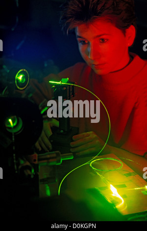 Eine Einrichtung für Experimente mit Lichtwelle Guide Kabel und Lasern. Ein Techniker wird ein Glasfaserkabel untersucht. Stockfoto