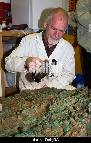 Neil Mahrer sprühen Wasser auf Jersey keltischen Münze Horten links von einem Coriosolite Stamm 50 BC, Jersey, Kanalinseln, UK Stockfoto