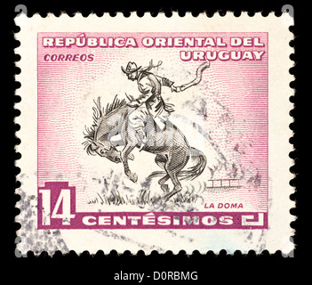 Briefmarke aus Uruguay Darstellung einen Rodeo-Reiter. Stockfoto