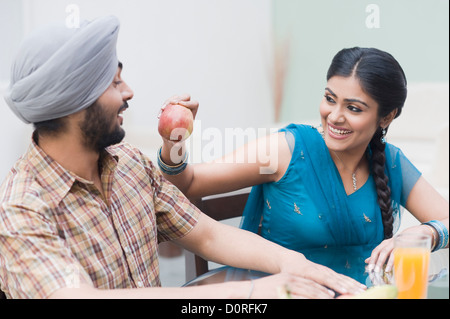 Fütterung einen Apfel mit einem Mann Frau Stockfoto