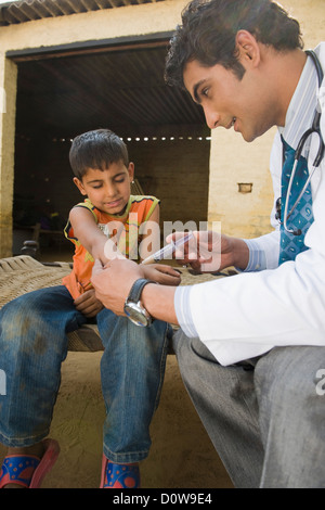 Arzt eine Injektion zu geben, einen jungen, Hasanpur, Haryana, Indien Stockfoto