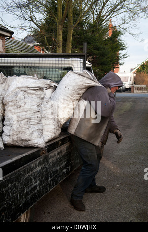 Man liefert Kohle zu einem Kunden-Haus in Lancashire. Stockfoto