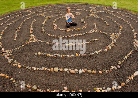 Frau im Steinlabyrinth meditieren Stockfoto