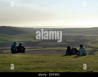 Wanderer nehmen einen Rest auf dem Gipfel des Mount caburn, ein Teil der South Downs in East Sussex. Stockfoto