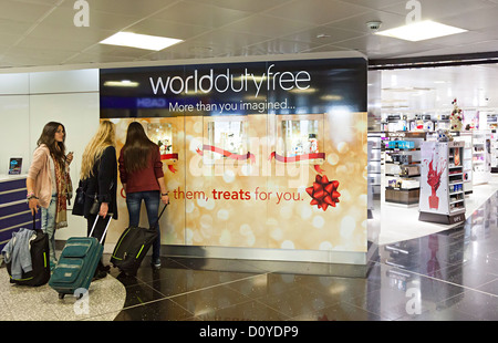 Welt der Duty Free shopping-Bereich mit drei Frauen Blick auf Angebote, Bristol Flughafen, England, UK Stockfoto