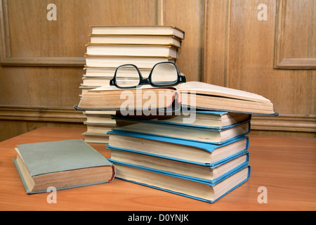 Stapel von Büchern und alten Gläser auf einem Tisch Stockfoto