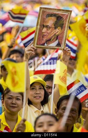 5. Dezember 2012 hält ein Foto von Bhumibol Adulyadej, der König von Thailand - Bangkok, Thailand - eine Frau auf der Royal Plaza Mittwoch während sie darauf wartet, den König vor seinem Publikum auf dem Mukkhadej Balkon Ananta Samakhom Throne Hall zu sehen. 5 Dezember ist ein nationaler Feiertag. Es ist auch als Vatertag gefeiert. Feierlichkeiten sind landesweit anlässlich des Geburtstags von Bhumibol Adulyadej, der König von Thailand statt. (Bild Kredit: Jack Kurtz/ZUMAPRESS.com ©) Stockfoto