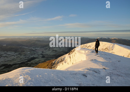 Walker, bewundern Sie die Aussicht vom Gipfel des Gategill fiel auf Blencathra im englischen Lake District im winter Stockfoto