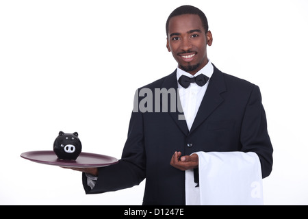 Kellner mit Sparschwein Stockfoto
