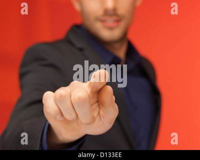gut aussehender Mann in Anzug, die virtuelle Taste Stockfoto