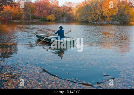 New York, NY - Mann 19. November 2010 ein Ruderboot im See im Central Park Stockfoto