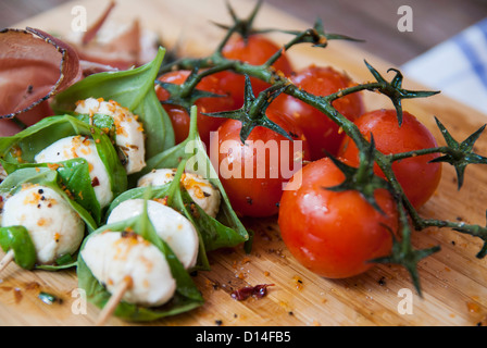 Käse mit Kräutern und Tomaten Stockfoto