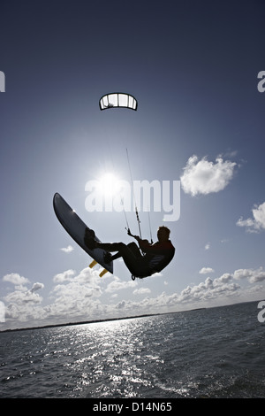 Mann-Kitesurfen auf ruhigem Wasser Stockfoto