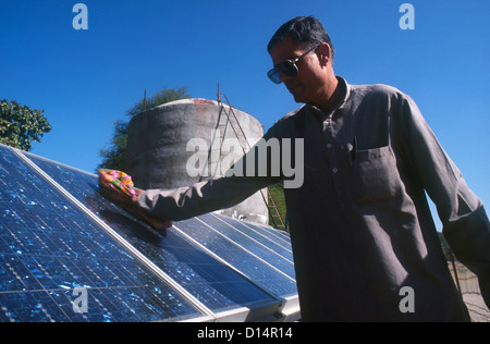 Indien Rajasthan, Mann sauber Solarpanel solar angetriebene Wasserpumpe, Wasser im Tank, Projekt barefoot College in Tilonia füllen Stockfoto