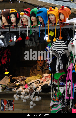 Brügge / Brugge, Belgien. Man Hüte auf einem Weihnachten Marktstand zu verkaufen Stockfoto